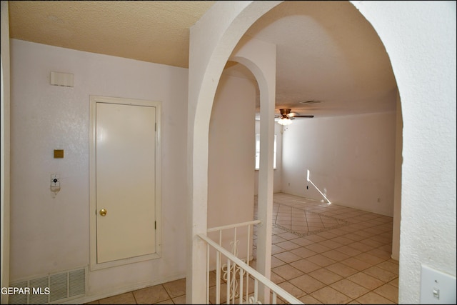 12560 Angie Bombach Ave, El Paso, TX 79928 - hallway featuring light tile patterned floors and a textured ceiling