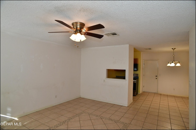 12560 Angie Bombach Ave, El Paso, TX 79928 - spare room with ceiling fan with notable chandelier, light tile patterned floors, and a textured ceiling
