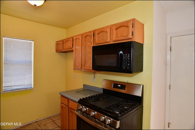 12560 Angie Bombach Ave, El Paso, TX 79928 - kitchen with gas range and light tile patterned floors