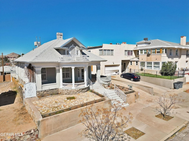 rear view of house with covered porch