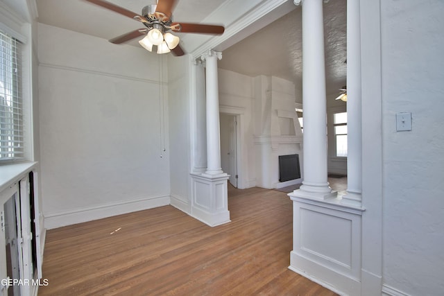 living room featuring ornate columns, ceiling fan, and hardwood / wood-style floors