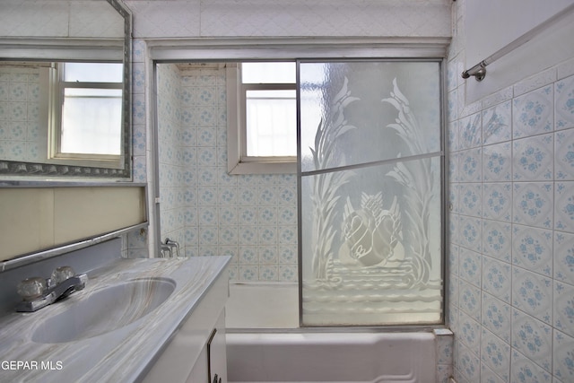 bathroom featuring vanity and enclosed tub / shower combo