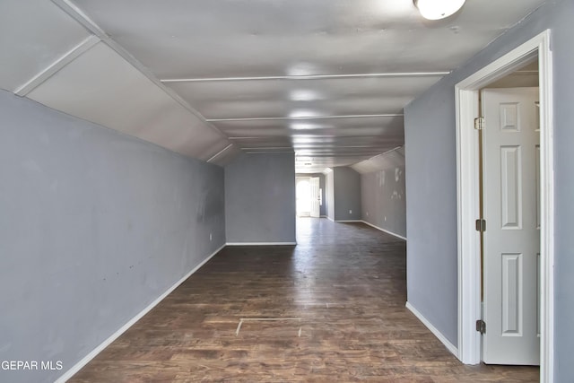 additional living space featuring lofted ceiling and dark wood-type flooring