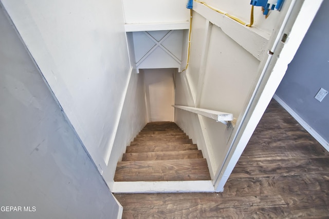 stairway with hardwood / wood-style flooring