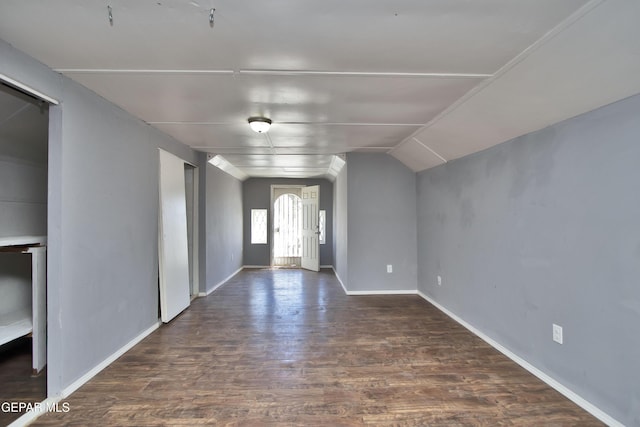 foyer entrance featuring lofted ceiling and dark wood-type flooring