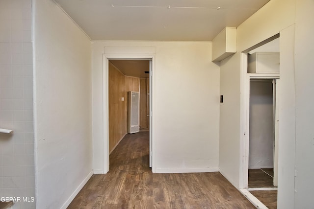 corridor with dark hardwood / wood-style flooring