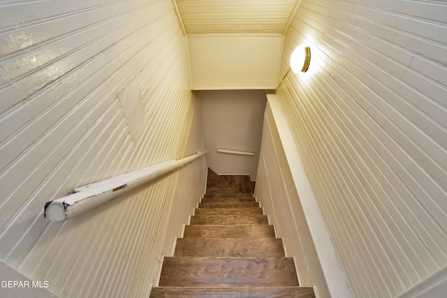 stairway with wood walls