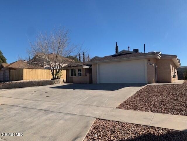 single story home featuring a garage