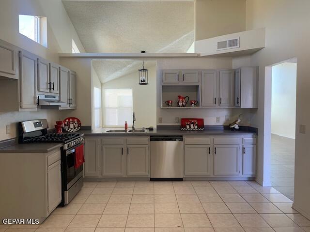 kitchen with sink, light tile patterned floors, stainless steel appliances, and a wealth of natural light