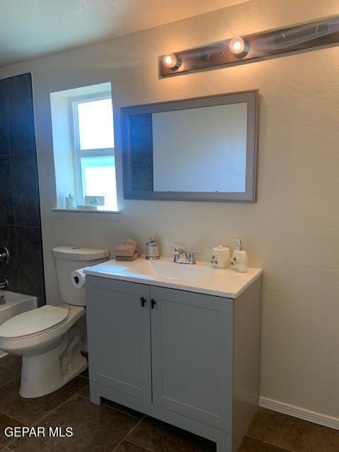 full bathroom with tile patterned flooring, vanity, toilet, and shower / tub combination