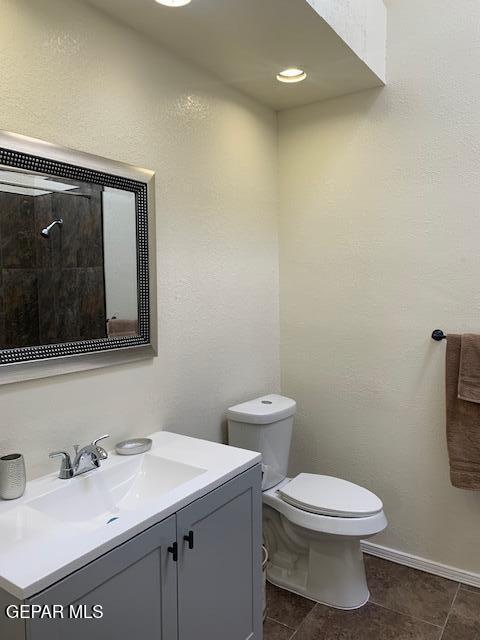 bathroom featuring tile patterned floors, vanity, and toilet