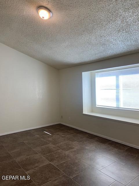 spare room featuring a textured ceiling