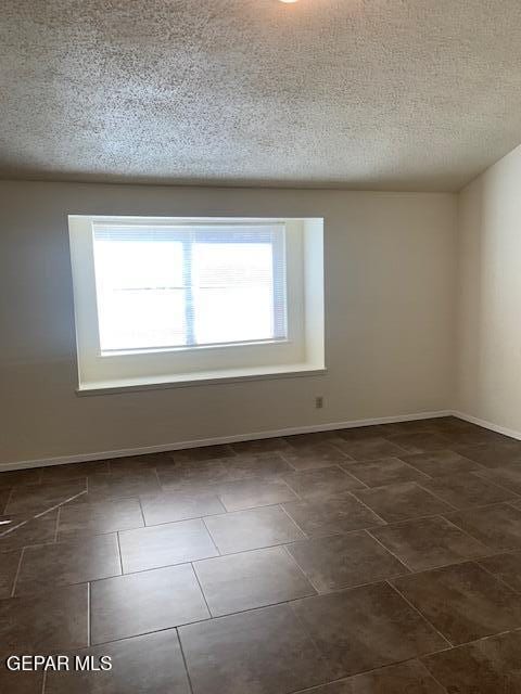 empty room featuring a textured ceiling