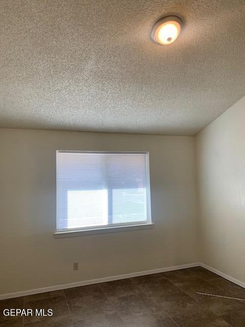 empty room featuring a textured ceiling