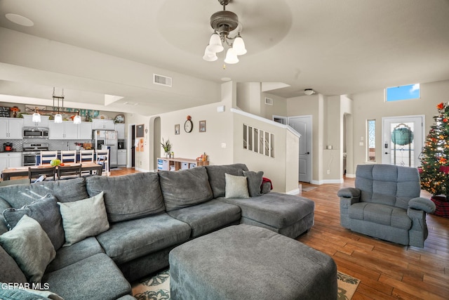 living room with hardwood / wood-style floors and ceiling fan