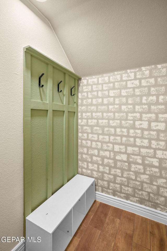 mudroom featuring dark hardwood / wood-style floors and vaulted ceiling