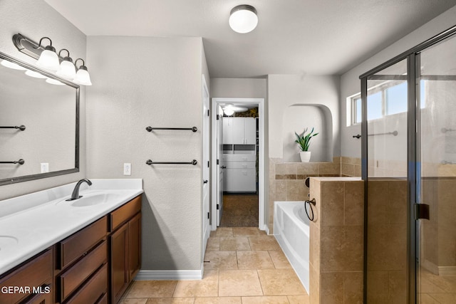 bathroom with tile patterned flooring, vanity, and independent shower and bath