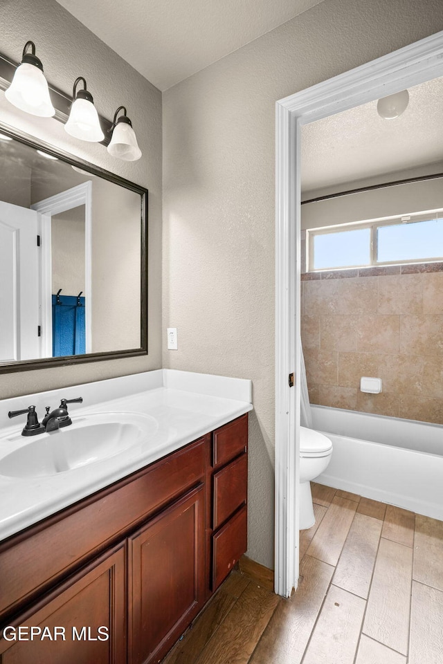 full bathroom featuring shower / bath combo, vanity, and toilet