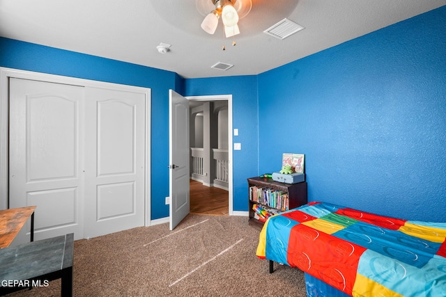 bedroom with carpet flooring, a closet, and ceiling fan