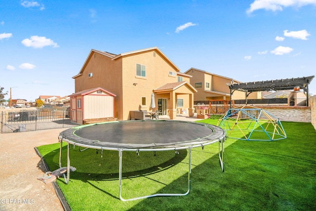 exterior space with a playground, a storage unit, a trampoline, and a pergola