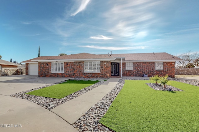 ranch-style house featuring a front yard and a garage