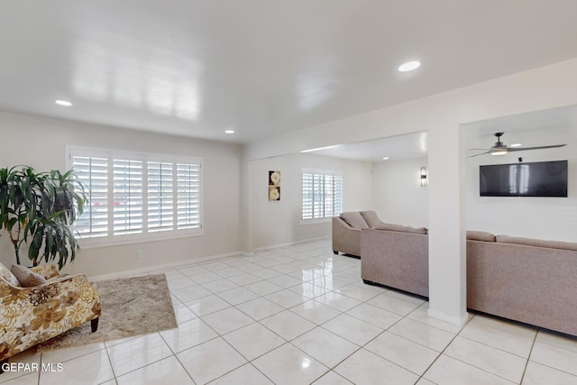 living room with ceiling fan, a healthy amount of sunlight, and light tile patterned flooring