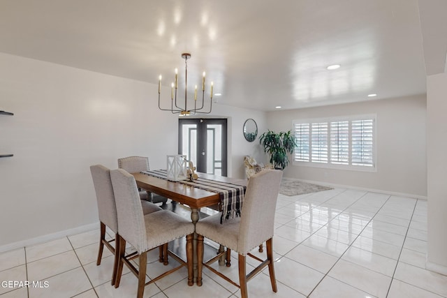 dining area with a notable chandelier and light tile patterned floors