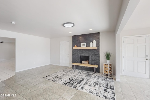 tiled living room featuring a brick fireplace