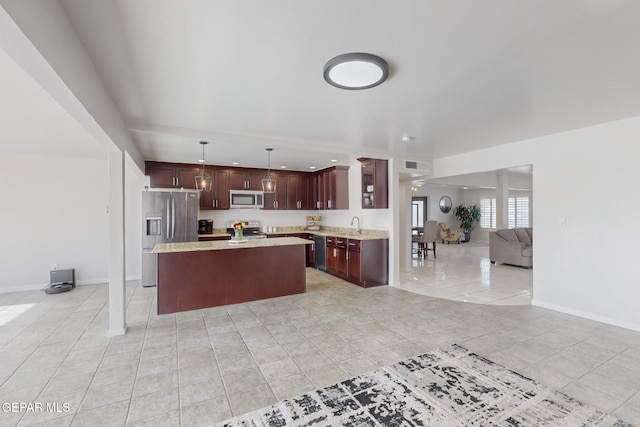 kitchen with a center island, sink, stainless steel appliances, pendant lighting, and light tile patterned floors