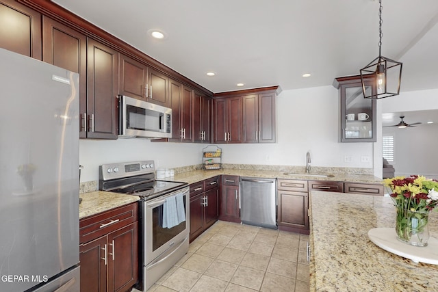 kitchen featuring sink, ceiling fan, light tile patterned floors, decorative light fixtures, and stainless steel appliances