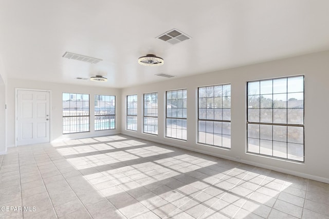 unfurnished sunroom featuring a wealth of natural light