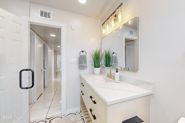 bathroom featuring tile patterned flooring and vanity