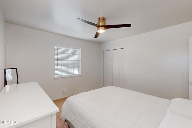 bedroom featuring ceiling fan and a closet