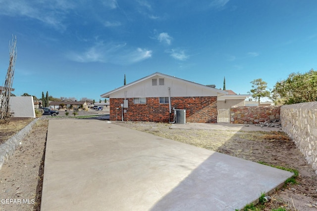 rear view of property featuring central AC unit