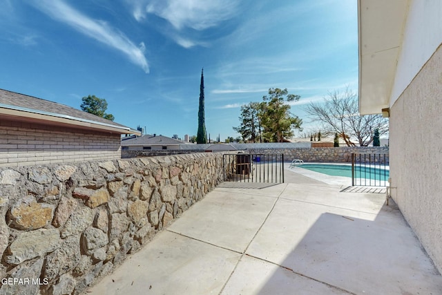 view of patio featuring a fenced in pool