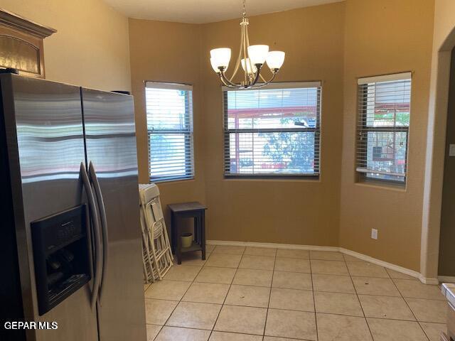 interior space with a notable chandelier and light tile patterned flooring