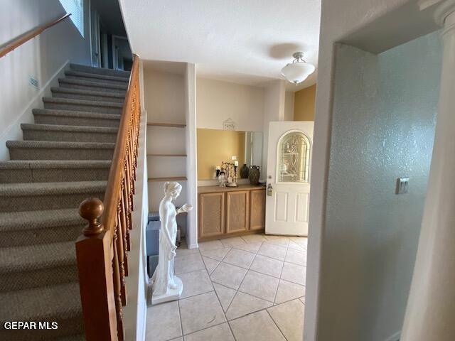 staircase with tile patterned floors