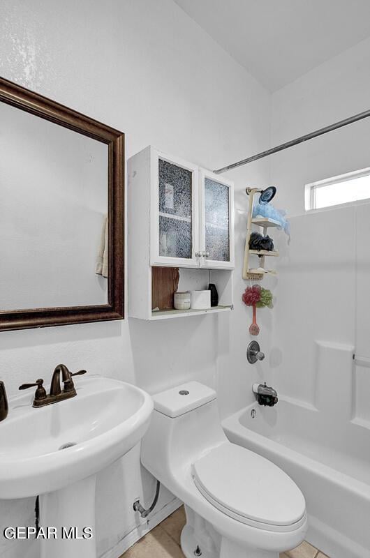 full bathroom featuring shower / bathing tub combination, tile patterned flooring, toilet, and sink