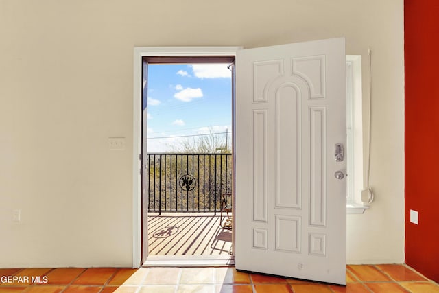 doorway to outside featuring light tile patterned floors