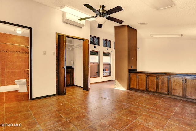 interior space featuring a textured ceiling and ceiling fan