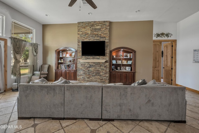 living room featuring built in shelves and ceiling fan