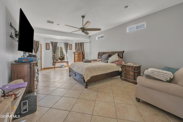 tiled bedroom featuring ceiling fan