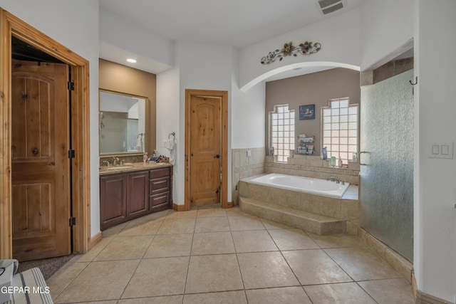 bathroom featuring tile patterned flooring, vanity, and independent shower and bath