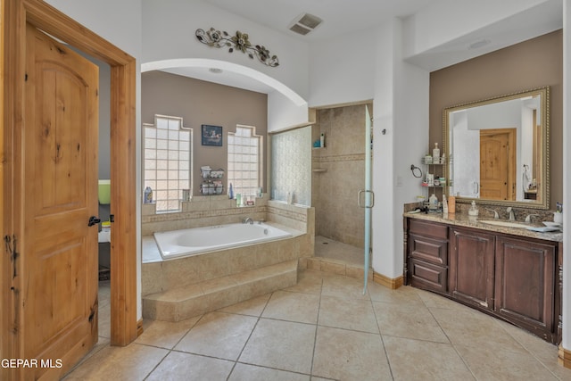 bathroom featuring tile patterned floors, separate shower and tub, and vanity