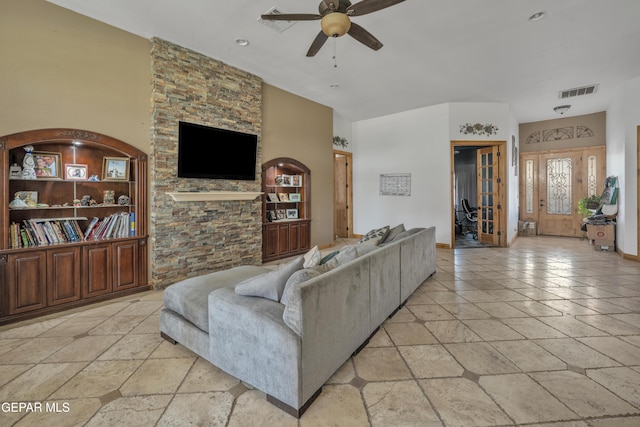 living room featuring french doors, built in features, and ceiling fan