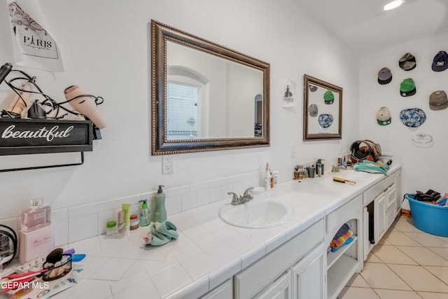 bathroom with tile patterned floors and vanity