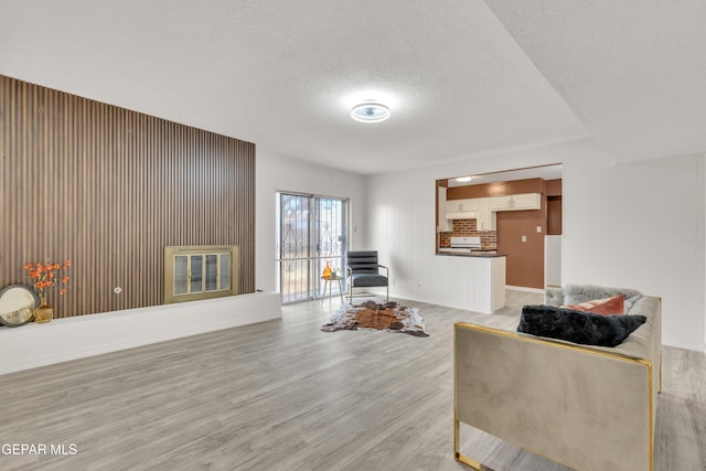 living room with hardwood / wood-style floors and a textured ceiling