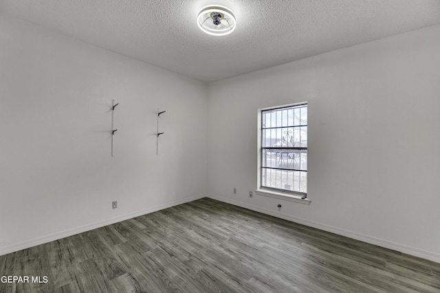 spare room with hardwood / wood-style floors and a textured ceiling