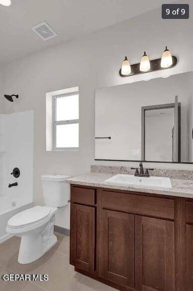 full bathroom featuring tile patterned floors, vanity,  shower combination, and toilet