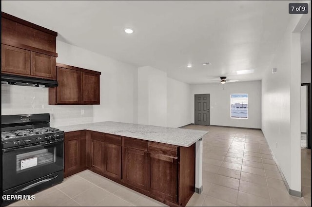 kitchen with kitchen peninsula, tasteful backsplash, light stone counters, black range with gas cooktop, and ceiling fan